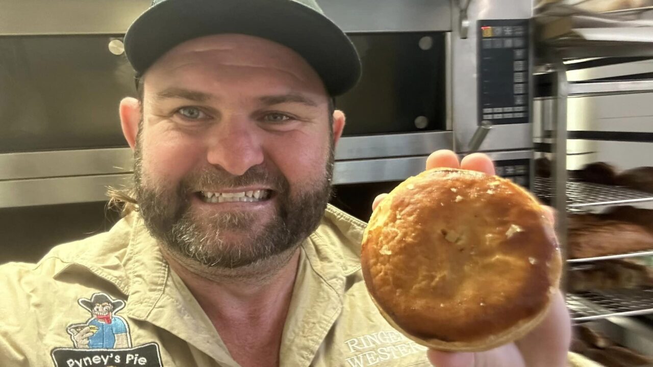 Shaun “Pyney the Pie Man” Pyne with Aussie meat pie.