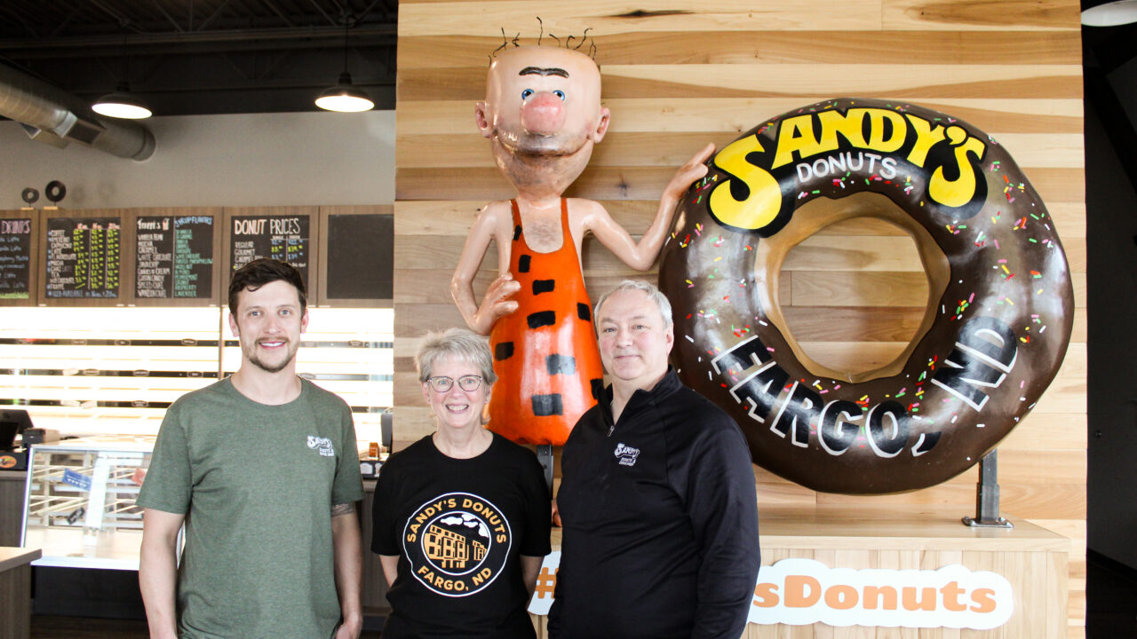 Jeff Ostlund, Joan Wilson and Kent Flagtwet of Sandy’s Donuts in Fargo, North Dakota.