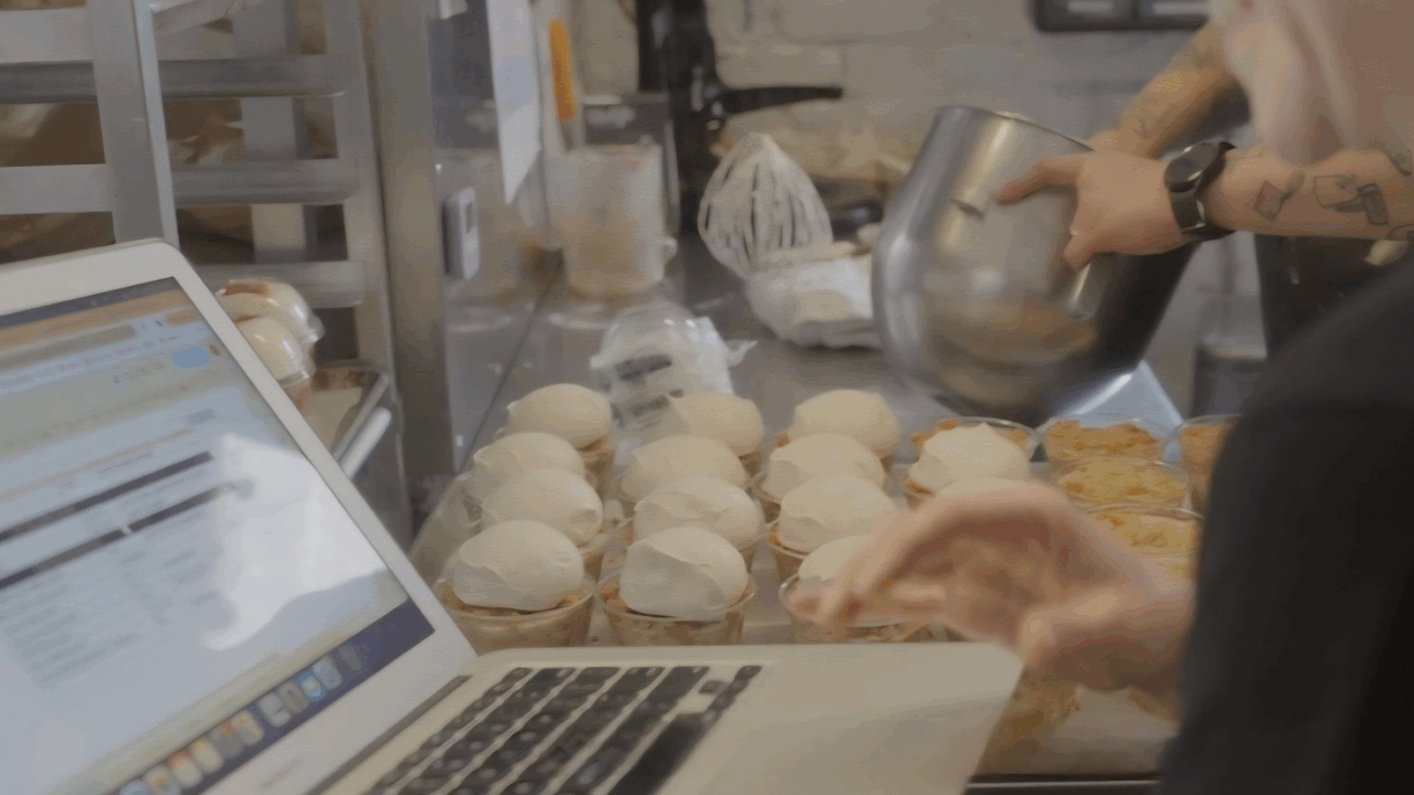 Photo of bakers using Cybake on a laptop