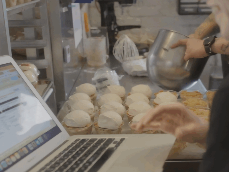 Photo of bakers using Cybake on a laptop
