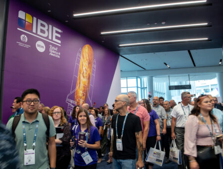 Photos of crowd of attendees entering the International Baking Industry Exposition in 2022.