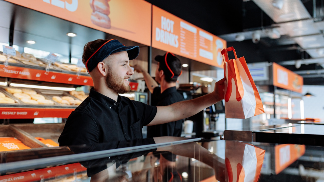 Photo of staff serving at the counter of a Wenzel's the Bakers retail store.