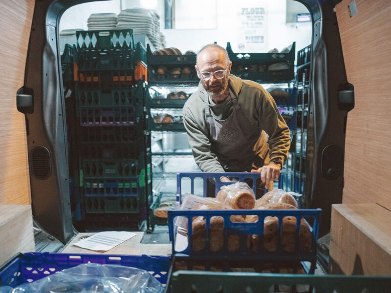 : Picture of Roger’s Bakery owner Roger Haycock filling one his delivery vans
