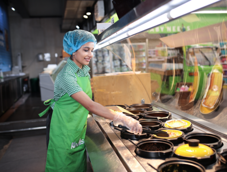 Photo of a store colleague at a Keells supermarket preparing food