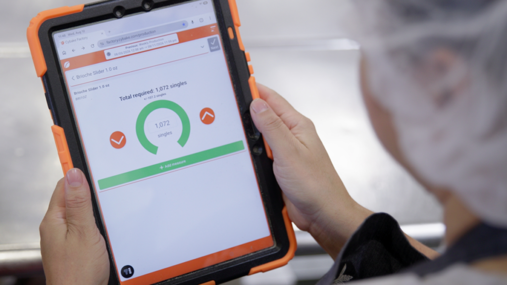 Photo of a baker at Macrina Bakery in Seattle using Cybake software on a tablet